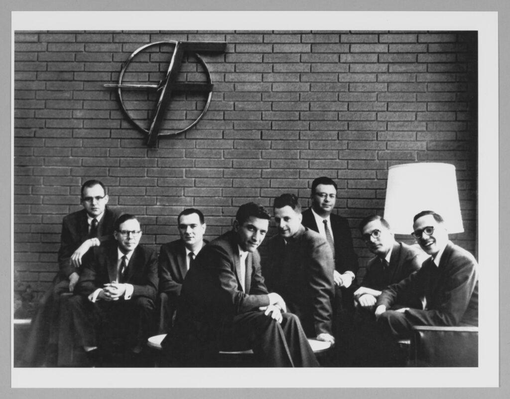 Fairchild founders pose under the “Flying F” logo in the company’s Mountain View lobby. From left: Gordon Moore, Sheldon Roberts, Eugene Kleiner, Robert Noyce, Victor Grinich, Julius Blank, Jean Hoerni and Jay Last. All photos Douglas Menuez and courtesy Stanford University Libraries.